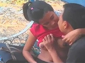 Desi boyfriend fondles his girlfriend's large breasts on a park bench