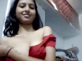 Busty girl stripping for her lover in a seductive video