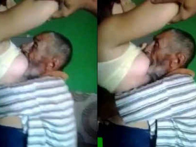 Overweight Arab woman breastfeeding elderly man