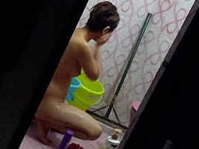 Hidden camera captures Indian babe washing her undies in the shower
