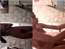 A stunning woman flaunts her breasts and soaps up in the shower