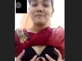 A stunning woman flaunts her big breasts and entices with her alluring pussy