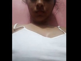An Indian girl reveals her large breasts and indulges in self-pleasure
