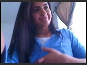 A charming girl flaunts her large, voluptuous breasts in a provocative manner on camera