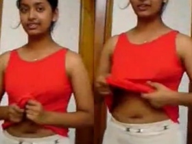 A young Indian woman reveals her breasts and belly button