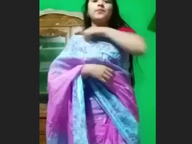 A stunning Indian woman removes her traditional sari and displays herself