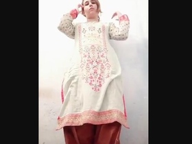 A pretty girl seductively displays her breasts and backside in a solo performance