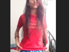 A stunning young woman undresses and displays her physique