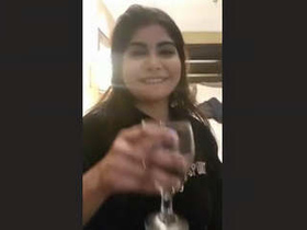 A seductive Pakistani escort reveals her breasts in a provocative display