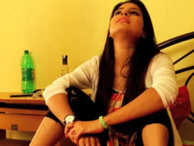 An Indian woman undresses and engages in intimate activities with her partner on film