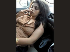 Indian escort Bushra undresses in a car in this heated video