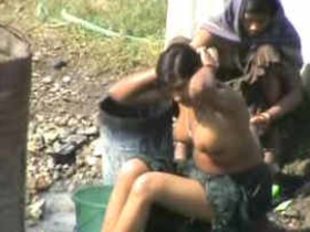 Indian office lady with attractive breasts bathes in the open air