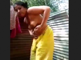 A young woman from a rural community takes a bath