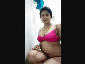 Young woman tapes herself undressed while pleasuring herself