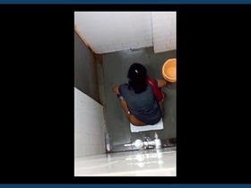 Secretly filmed women engage in intimate activities in bathroom