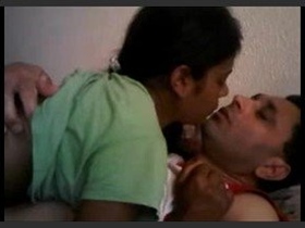 A youthful pair delves into their sensuality within the confines of their bedroom, engaging in passionate kisses