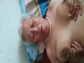 Elderly Chinese woman offers sexual services with drooping breasts