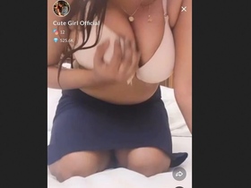 The adorable Tango girl flaunts her stunning cleavage in this official video