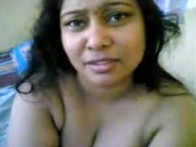 Indian wife showcases her large breasts while bathing