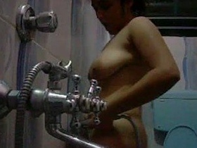 A college girl pleasures herself in the restroom privately