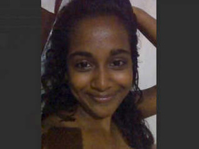 A Sri Lankan woman displays her large breasts