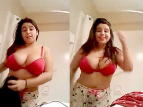 A South Asian woman fondles her large breasts and buttocks while switching outfits