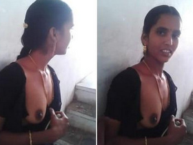 Elderly woman displays private assets to nearby resident behind apartment