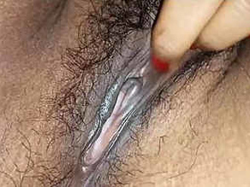 Aroused Indian woman stimulates her unshaven genitalia with her fingers