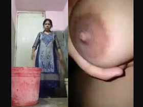 Indian aunty in the restroom washing and unveiling her ample bosom