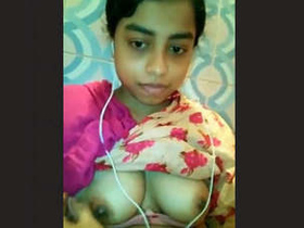 A sultry Indian beauty reveals her cleavage and intimate areas