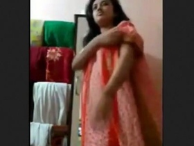 Indian woman undressing and revealing her large breasts and vagina