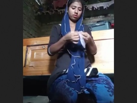 A young Bengali woman indulges in self-pleasure with a condom